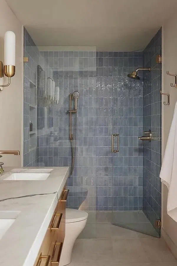 modern-blue-tile-shower-brass-fixtures