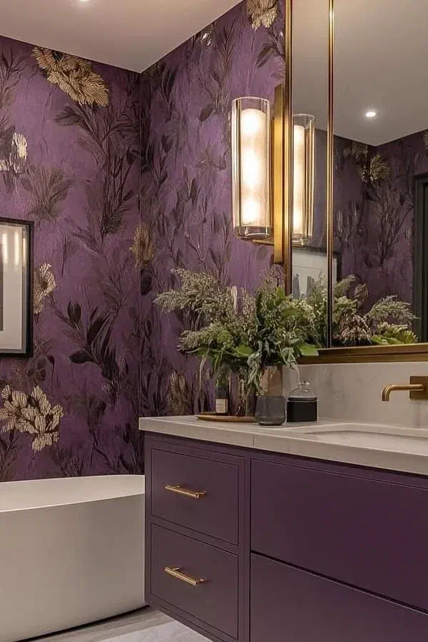 Bold bathroom with dramatic purple floral wallpaper, a matching purple vanity, and a large mirror.