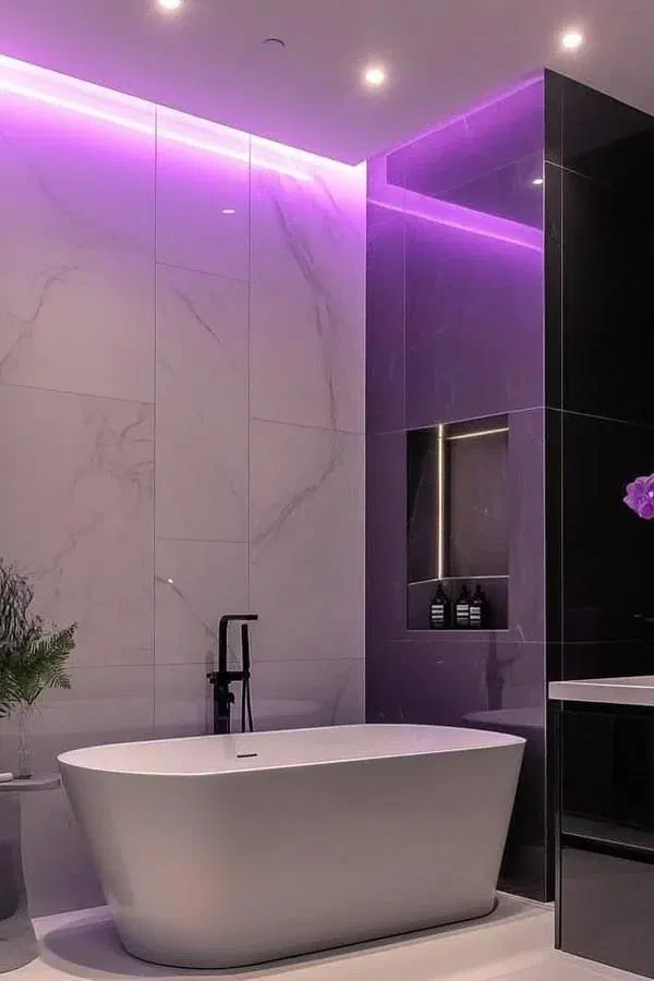 Modern bathroom with purple LED ambient lighting, a freestanding white tub, and sleek marble walls.