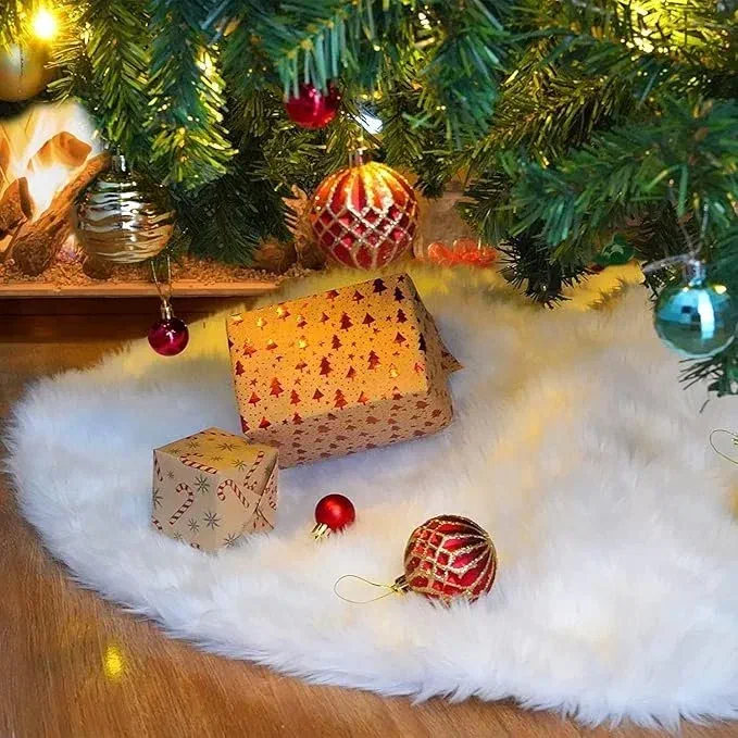 White faux fur tree skirt under a Christmas tree with wrapped gifts and ornaments scattered on top