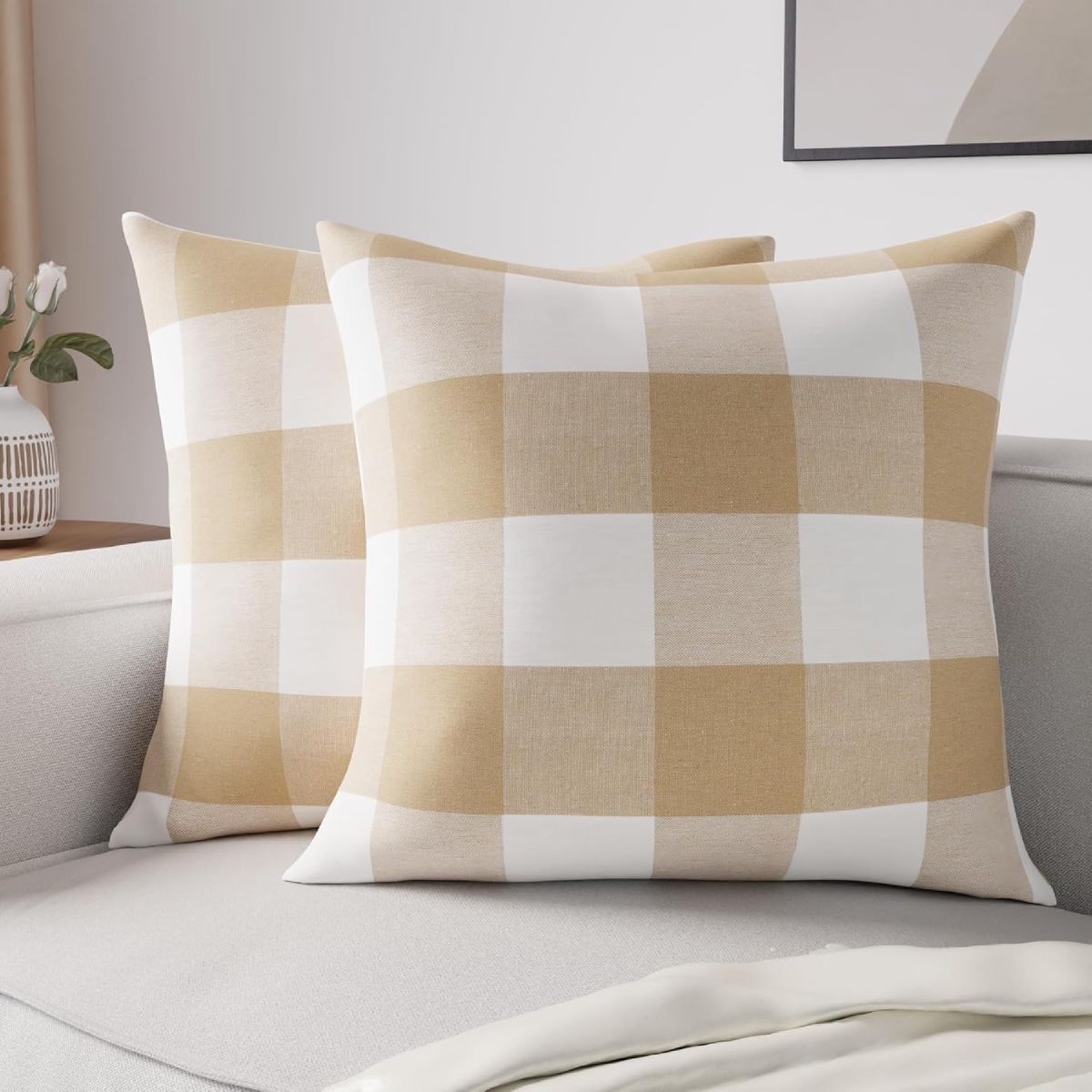 Two beige-and-cream buffalo check throw pillow covers styled on a light gray sofa