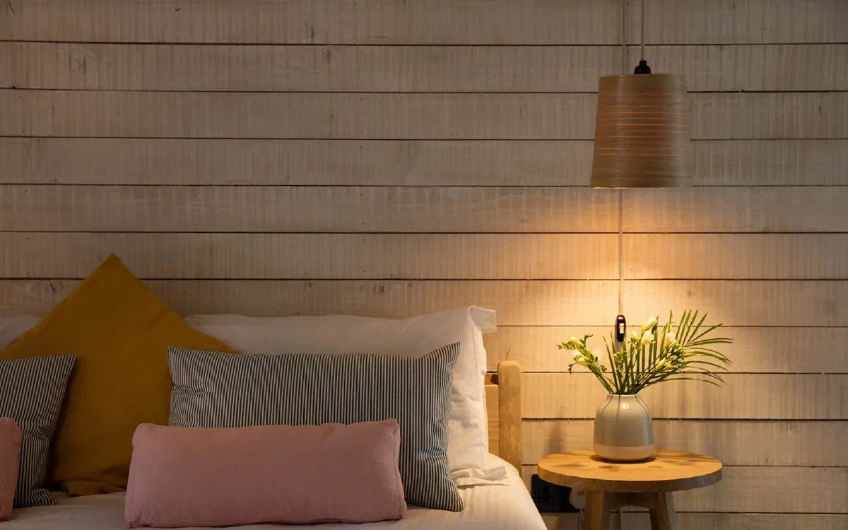 This bedroom has a cool hanging light perfect for reading or homework, showing how task lighting helps you focus.