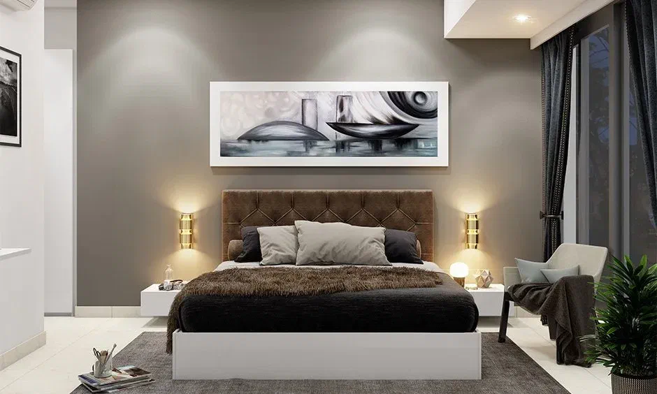 Bedroom with symmetrical wall sconce lighting, showing how to use sconces to frame a bed and artwork.