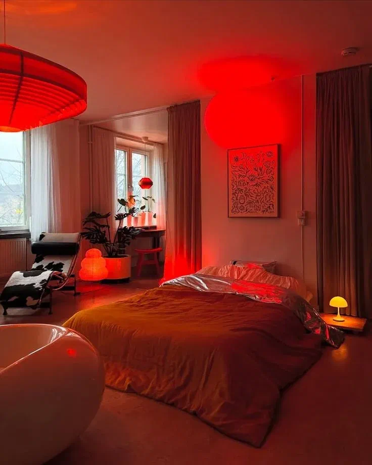 Romantic lighting effect in a bedroom using red laser lights to create a starry ambiance.