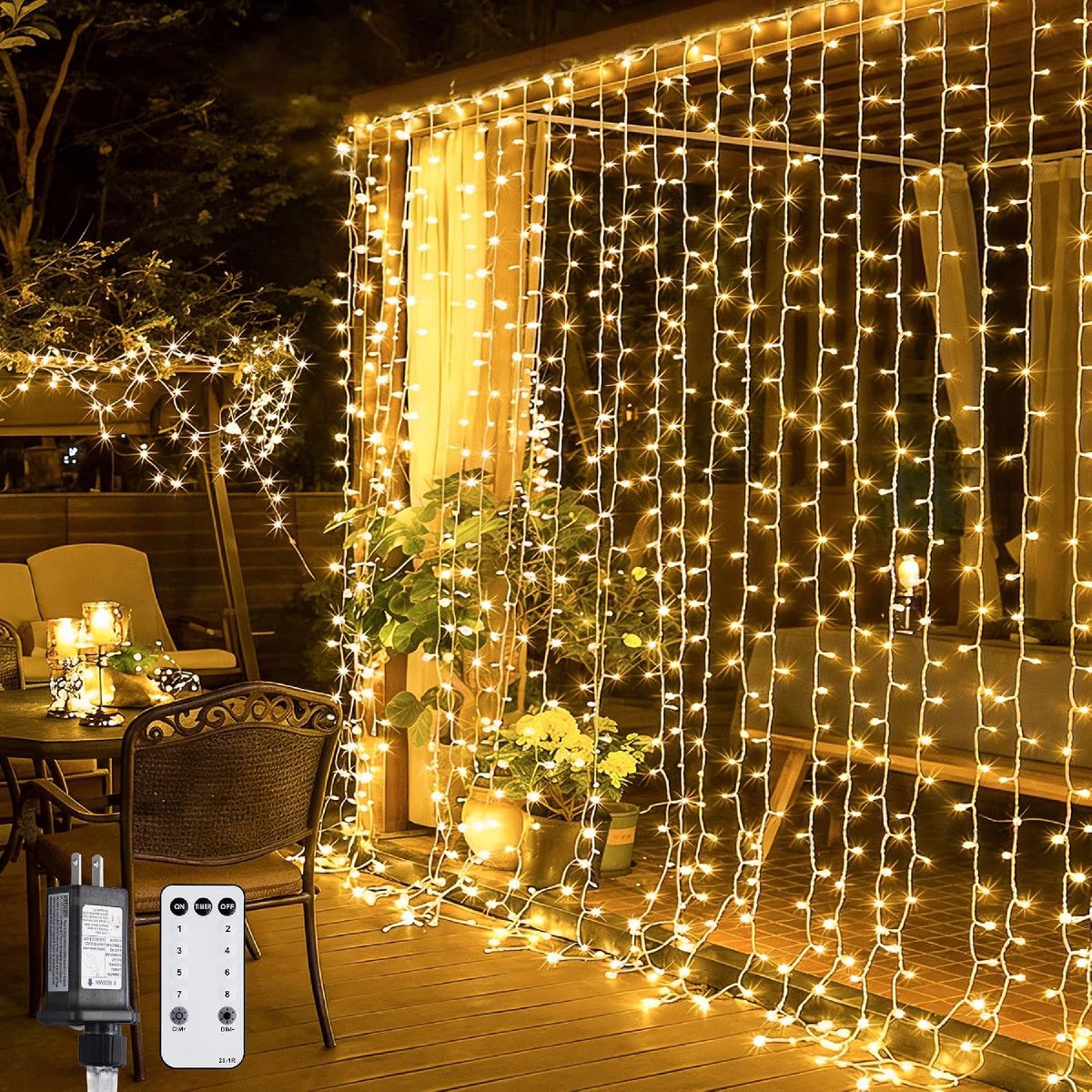 JMEXSUSS warm white curtain lights covering a patio pergola, with the plug adapter and remote control shown in front
