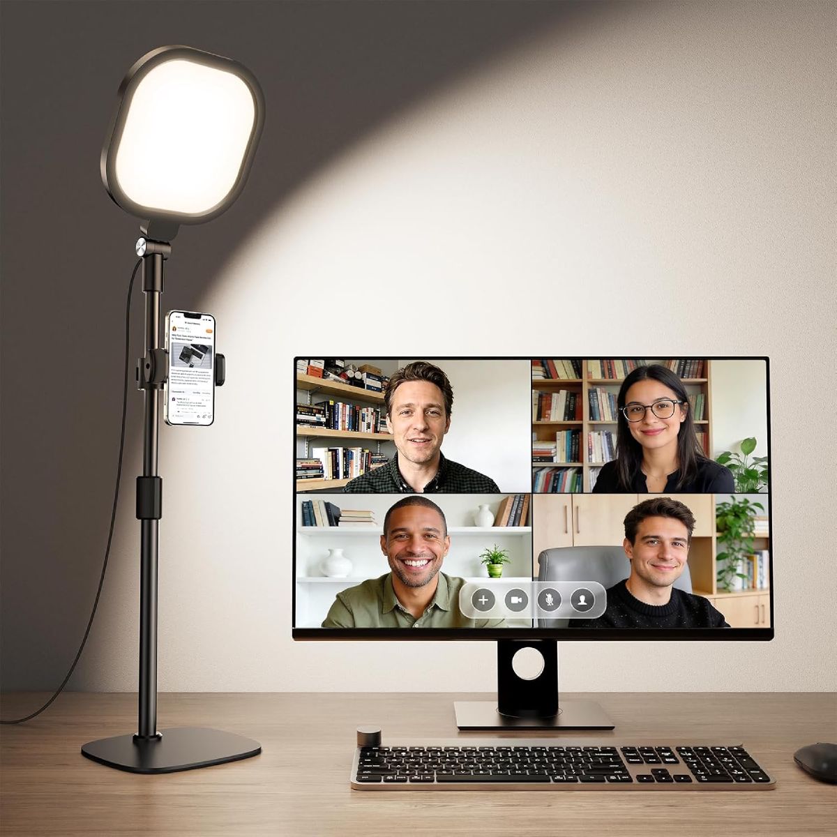 LitONES desk video conference light on an adjustable stand beside a laptop, casting soft even light onto a person’s face for a video call.