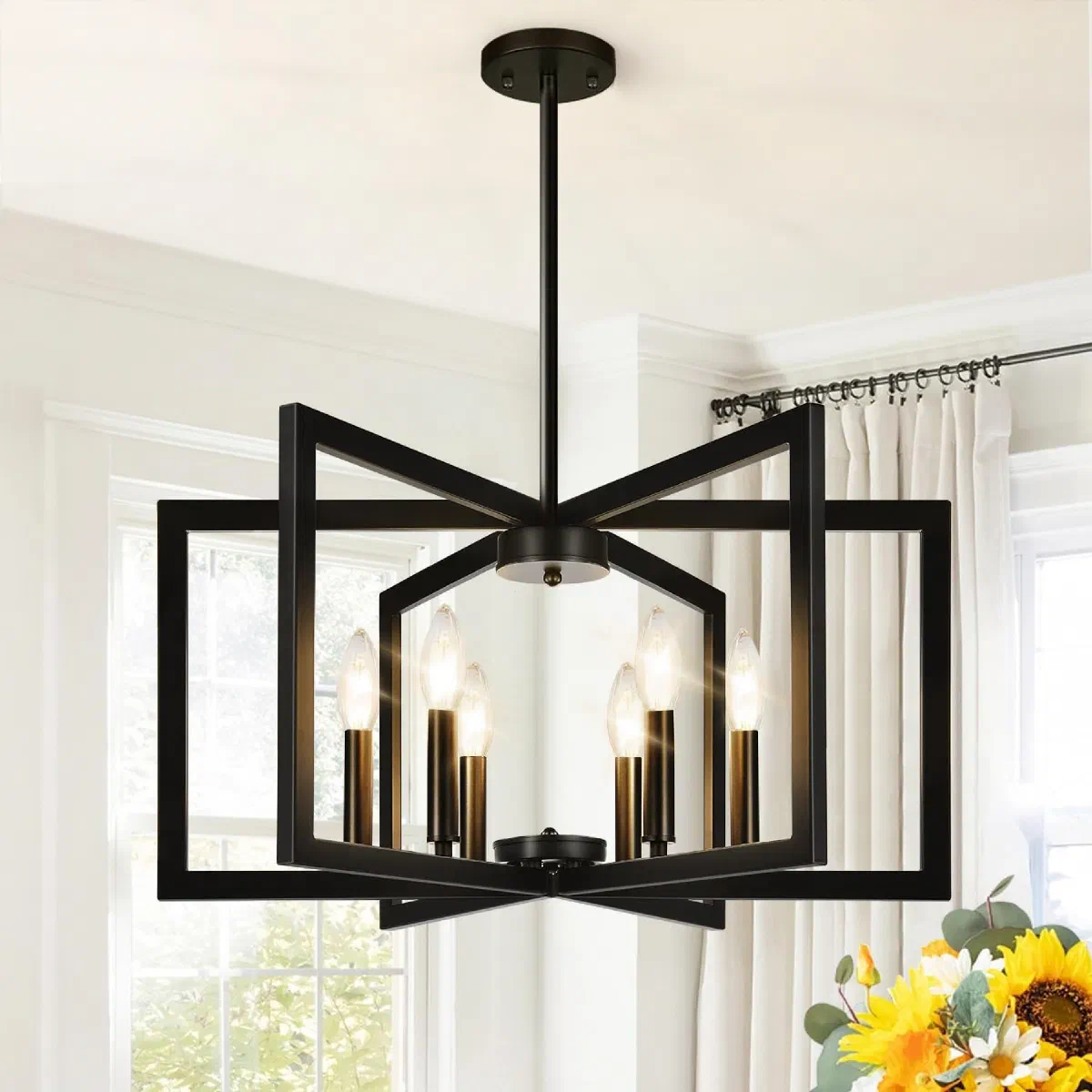 25-inch height-adjustable matte black chandelier hanging over a rectangular dining table