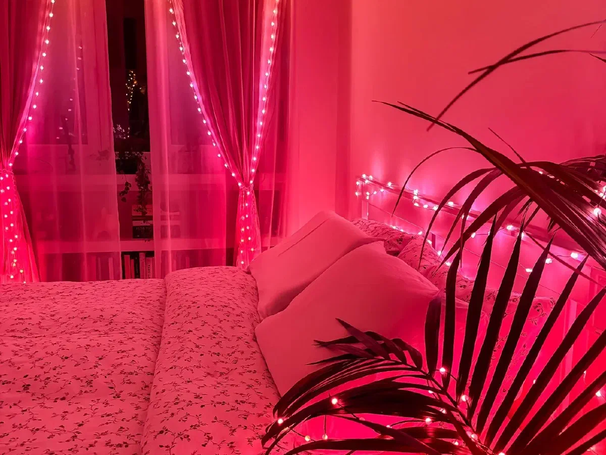 Pink fairy lights in a bedroom