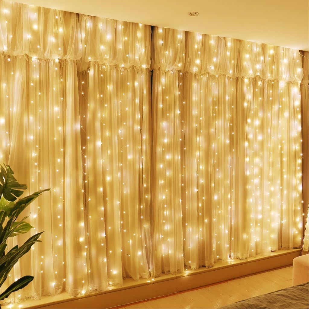 HXWEIYE curtain fairy lights lit up behind sheer curtains across a full window, warm white glow