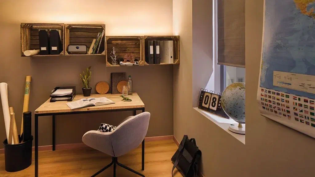 Small home office with natural light from a window and additional overhead lighting