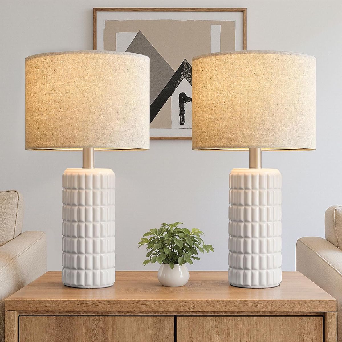 Set of two 23-inch modern ceramic bedside lamps in cream-white with linen shades.