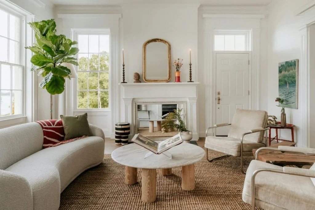 Light-colored walls, plenty of windows, and neutral furniture make this entry/living room feel extra bright