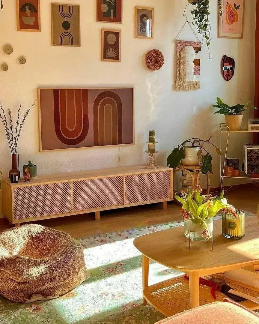 Bohemian living room with a gallery wall of colorful prints, a woven pouf, and a rattan-and-cane coffee table on a floral rug