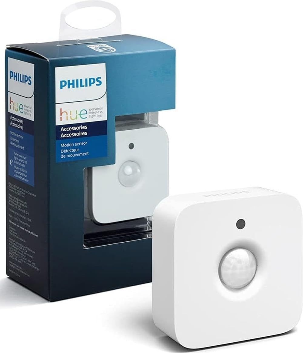 White Philips Hue wireless motion sensor with its retail packaging showing the passive infrared lens.