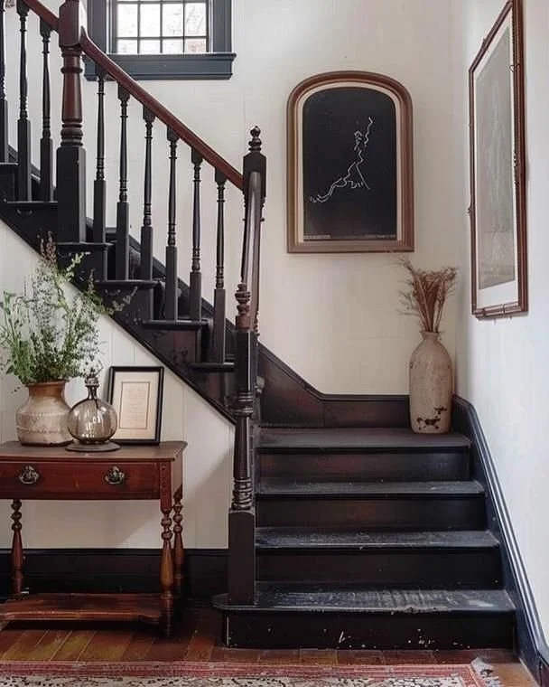 Back wooden staircase with gallery wall