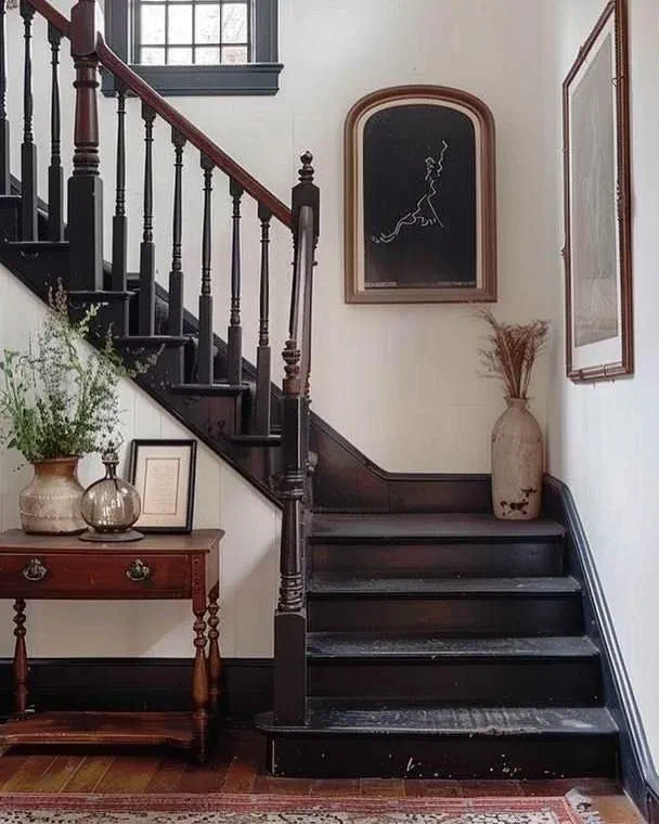 Back wooden staircase with gallery wall